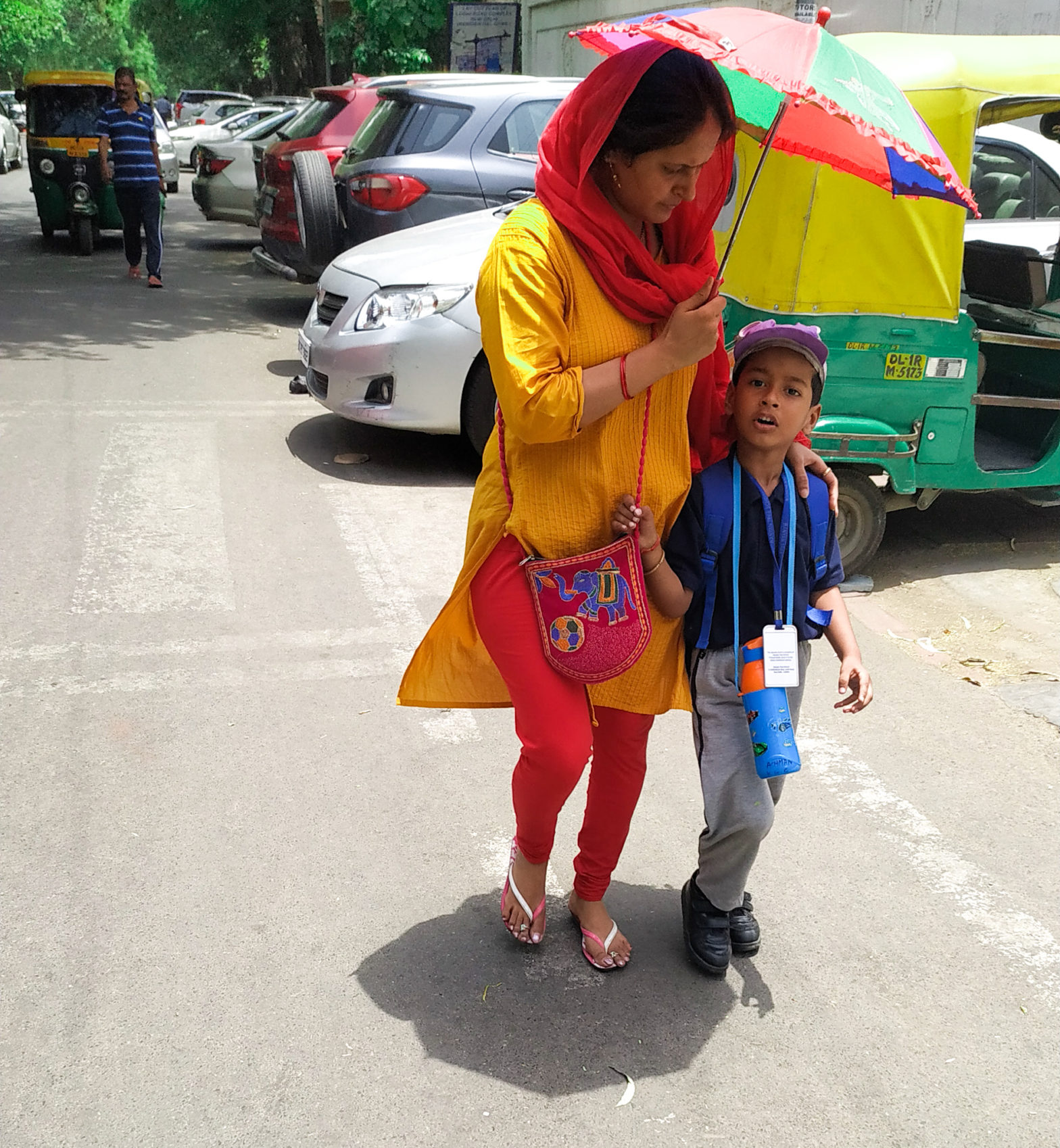 Caring Mother bringing the kid from school in a hot summer day. Photo By: Aniket Daima